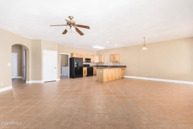 kitchen with ceiling fan, a kitchen breakfast bar, decorative light fixtures, light tile patterned floors, and black appliances