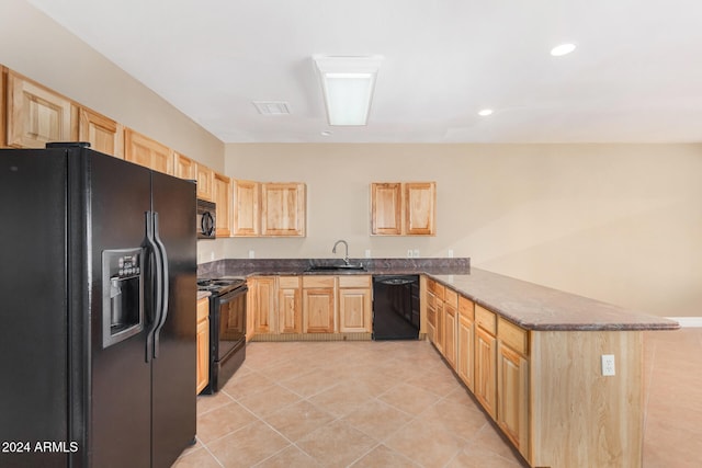 kitchen featuring black appliances, sink, light tile patterned floors, light brown cabinetry, and kitchen peninsula