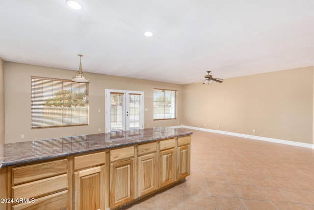 kitchen featuring pendant lighting, plenty of natural light, ceiling fan, and light tile patterned floors