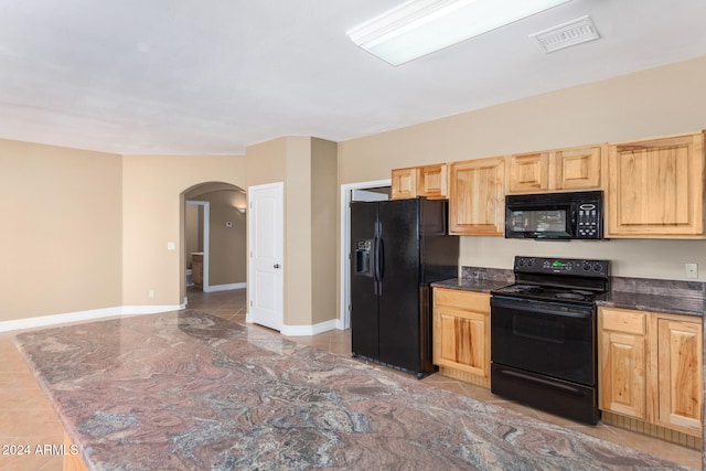 kitchen featuring black appliances and light brown cabinets