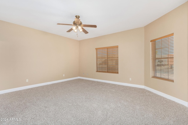 carpeted empty room featuring ceiling fan