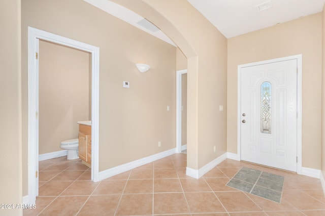 foyer featuring light tile patterned flooring