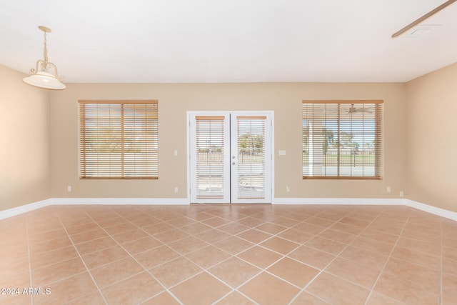 unfurnished room featuring french doors and light tile patterned floors