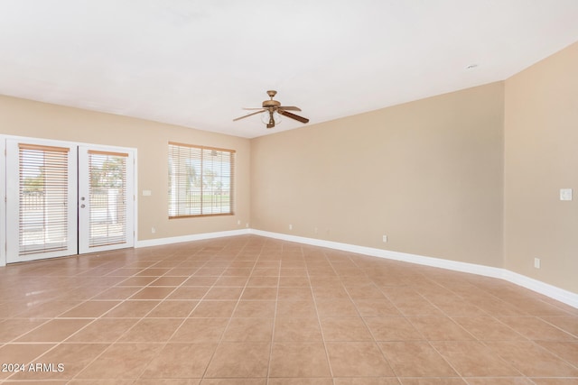 empty room with light tile patterned floors and ceiling fan