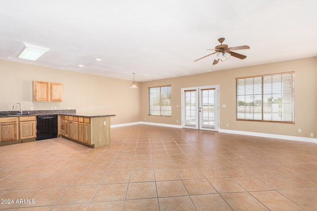 kitchen featuring dishwasher, sink, kitchen peninsula, decorative light fixtures, and light tile patterned flooring