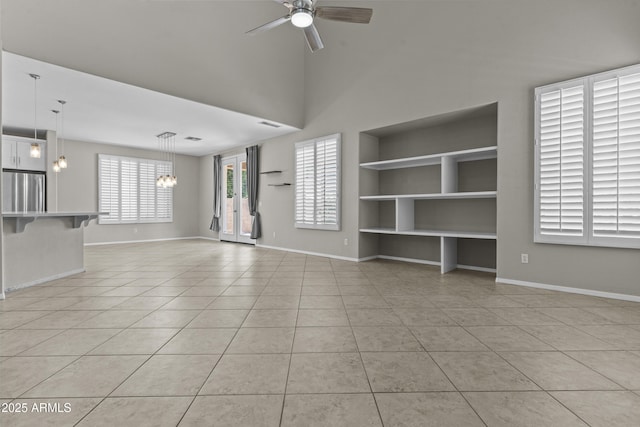 1162 E Ranch Ct, Gilbert, AZ 85296 - unfurnished living room featuring light tile patterned flooring, ceiling fan, built in shelves, and a chandelier
