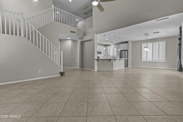 1162 E Ranch Ct, Gilbert, AZ 85296 - unfurnished living room featuring ceiling fan, light tile patterned flooring, baseboards, stairway, and recessed lighting
