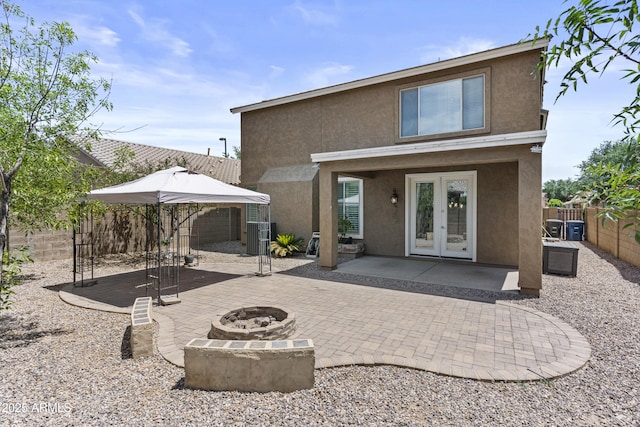 1162 E Ranch Ct, Gilbert, AZ 85296 - back of property featuring french doors, stucco siding, a patio area, a fire pit, and a fenced backyard