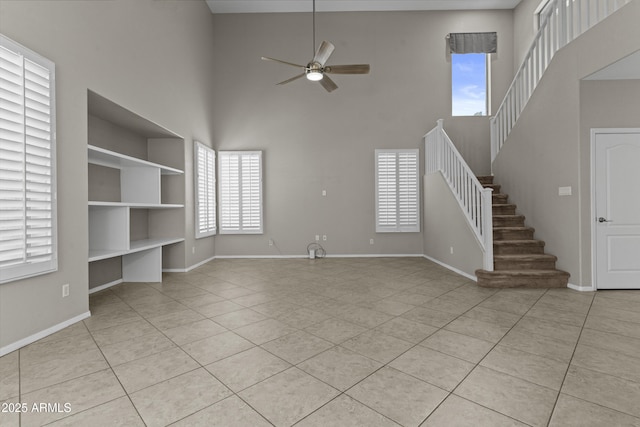 1162 E Ranch Ct, Gilbert, AZ 85296 - unfurnished living room with a high ceiling, a ceiling fan, light tile patterned floors, stairs, and baseboards