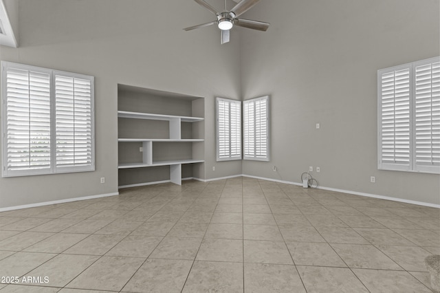 1162 E Ranch Ct, Gilbert, AZ 85296 - spare room featuring a ceiling fan, a high ceiling, built in shelves, and baseboards