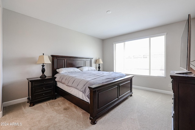 bedroom featuring light carpet