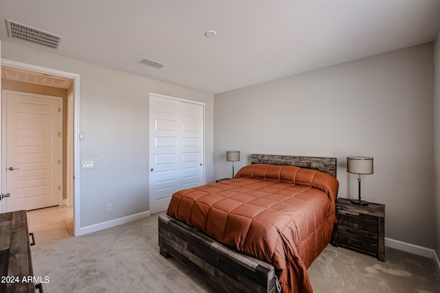 carpeted bedroom featuring a closet