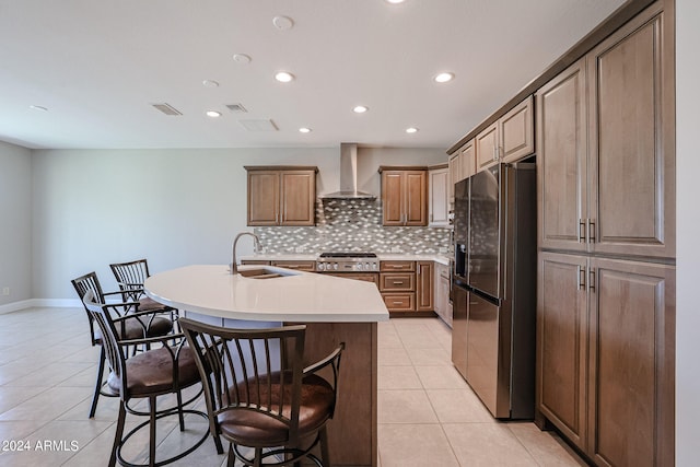 kitchen with backsplash, sink, black fridge with ice dispenser, light tile patterned floors, and wall chimney range hood