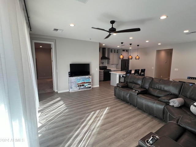 living room with wood-type flooring and ceiling fan