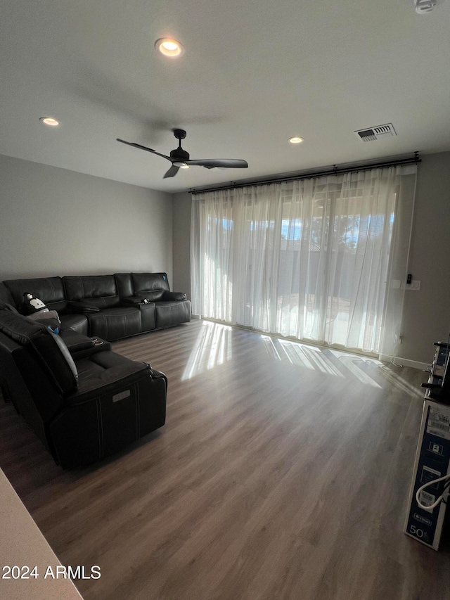 living room with wood-type flooring and ceiling fan