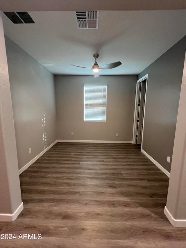 empty room featuring ceiling fan and dark hardwood / wood-style flooring