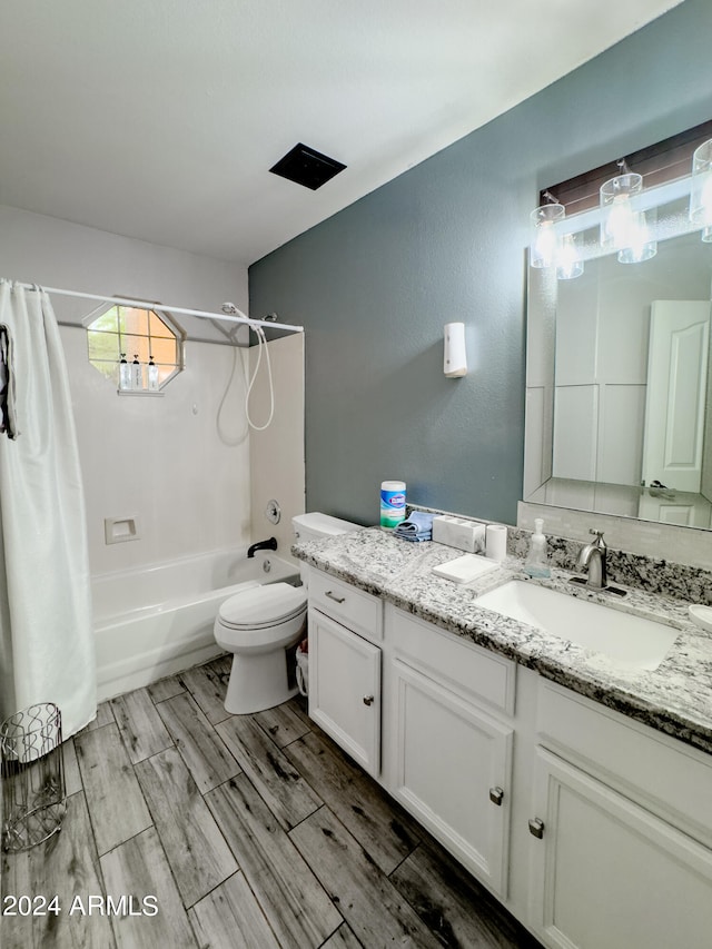 full bathroom featuring vanity, toilet, wood-type flooring, and shower / tub combo