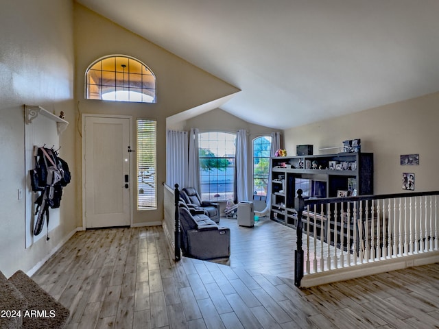 foyer entrance featuring light hardwood / wood-style floors and lofted ceiling