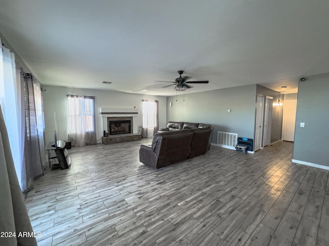 living room with ceiling fan and light wood-type flooring