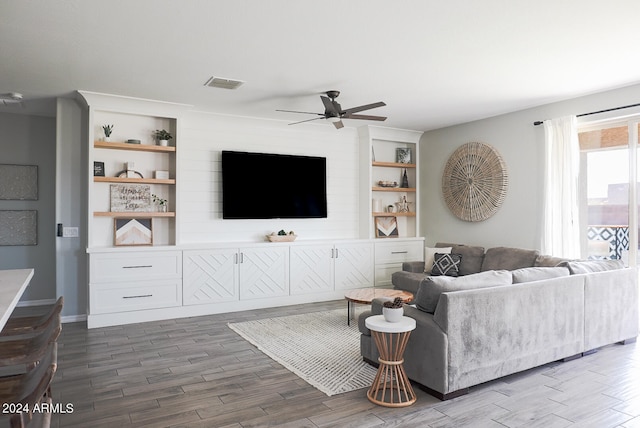 living room with dark hardwood / wood-style floors and ceiling fan