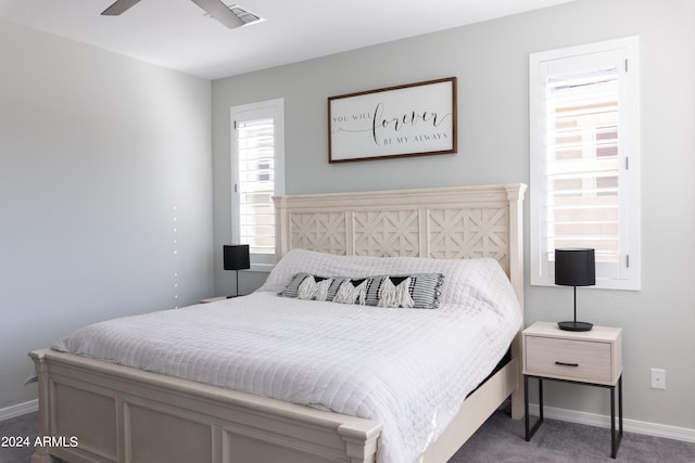 bedroom with carpet flooring, multiple windows, and ceiling fan