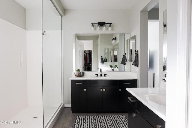 bathroom featuring a shower, wood-type flooring, and vanity