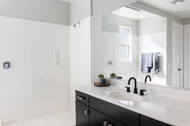 bathroom featuring vanity and walk in shower