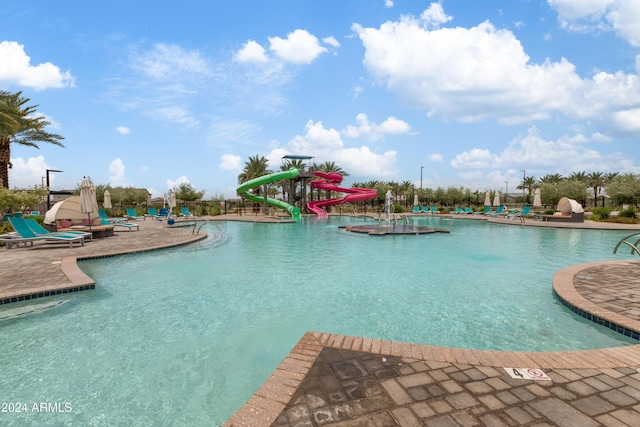 view of swimming pool featuring a patio area and a water slide