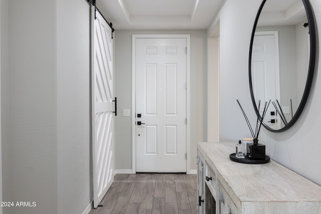 doorway with a barn door and light hardwood / wood-style flooring