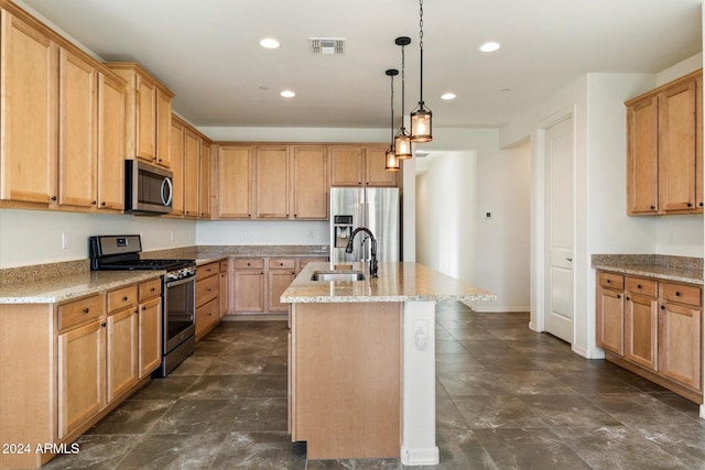 kitchen featuring light stone countertops, sink, stainless steel appliances, an island with sink, and pendant lighting