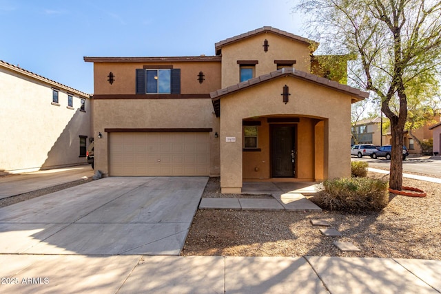 mediterranean / spanish home with driveway, a tile roof, a garage, and stucco siding