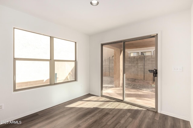 spare room with recessed lighting, baseboards, and wood finished floors