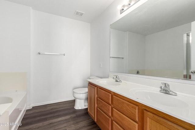 full bath featuring a bath, visible vents, a sink, and wood finished floors