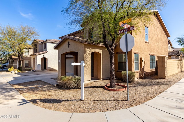 view of front of home with a tile roof and stucco siding