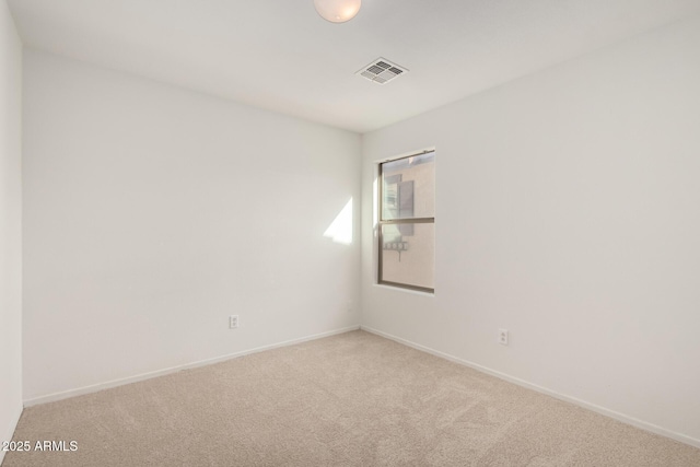 carpeted empty room with visible vents and baseboards