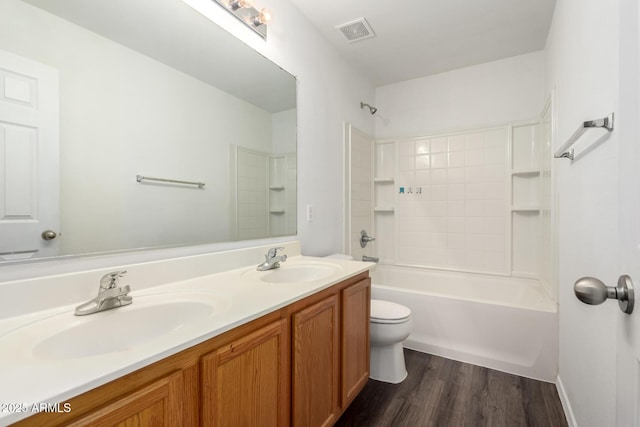 full bathroom with toilet, visible vents, a sink, and wood finished floors