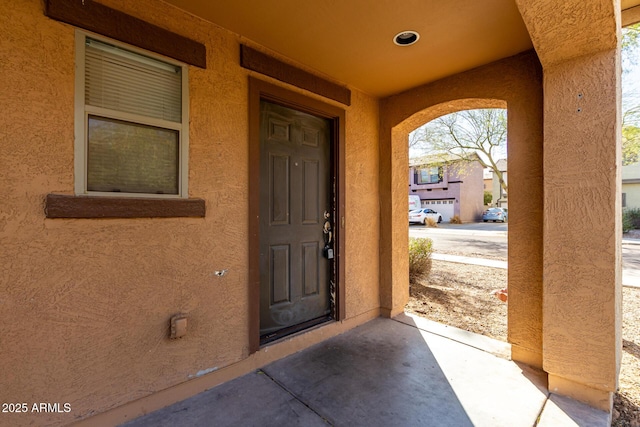 view of exterior entry featuring stucco siding