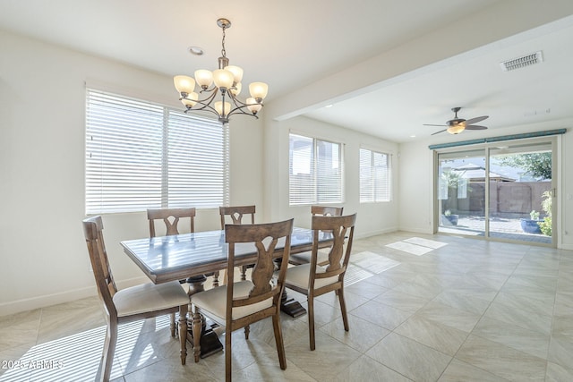 dining space with baseboards, a chandelier, and ceiling fan