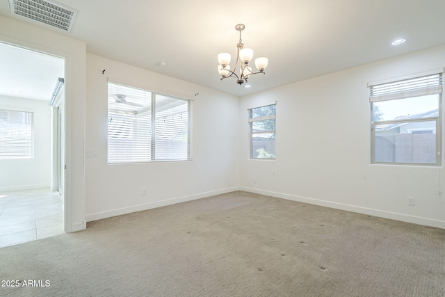 spare room with a chandelier, light colored carpet, baseboards, and recessed lighting