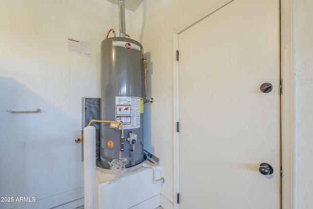 utility room featuring gas water heater