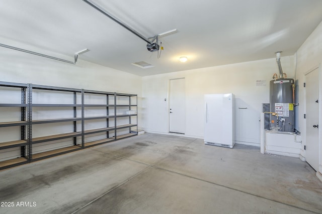 garage featuring freestanding refrigerator, gas water heater, and a garage door opener