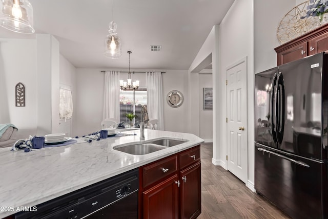 14864 W Riviera Dr, Surprise, AZ 85379 - kitchen featuring black appliances, a chandelier, dark wood-style floors, hanging light fixtures, and light stone counters