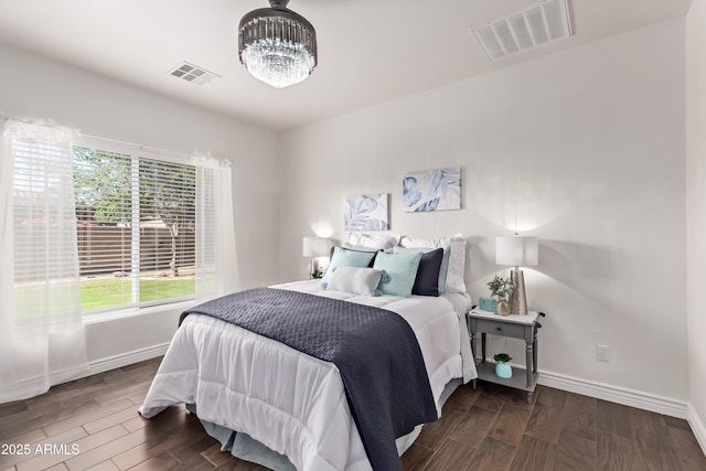 14864 W Riviera Dr, Surprise, AZ 85379 - bedroom featuring multiple windows, a chandelier, and wood finished floors