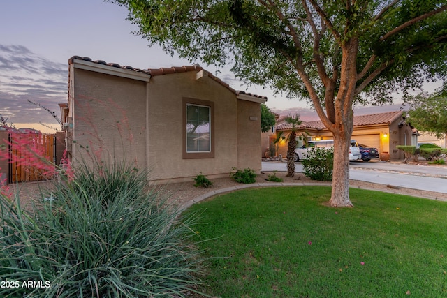 14864 W Riviera Dr, Surprise, AZ 85379 - mediterranean / spanish-style home with a tiled roof, a front yard, curved driveway, and an attached garage