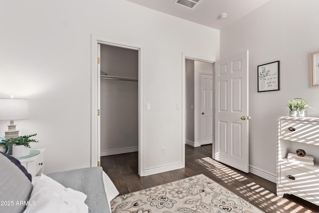 14864 W Riviera Dr, Surprise, AZ 85379 - bedroom with wood finished floors, a walk in closet, and a closet