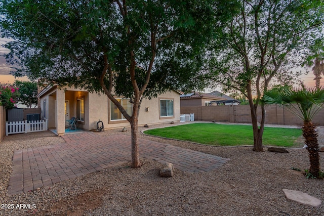 14864 W Riviera Dr, Surprise, AZ 85379 - back of house with a patio area, a fenced backyard, and stucco siding