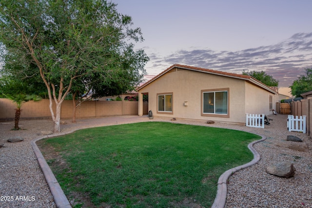 14864 W Riviera Dr, Surprise, AZ 85379 - rear view of property featuring stucco siding, a fenced backyard, and a patio area