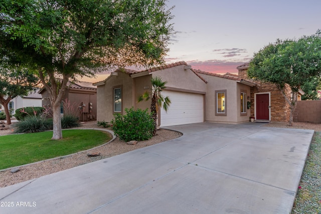 14864 W Riviera Dr, Surprise, AZ 85379 - view of front facade with stucco siding, concrete driveway, an attached garage, and a tile roof