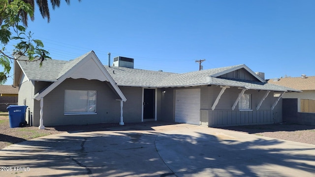 2908 N 53rd Ln, Phoenix, AZ 85031 - view of front of house featuring concrete driveway, a garage, a chimney, roof with shingles, and a porch