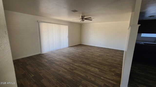 2908 N 53rd Ln, Phoenix, AZ 85031 - spare room with ceiling fan, wood finished floors, brick wall, and healthy amount of natural light